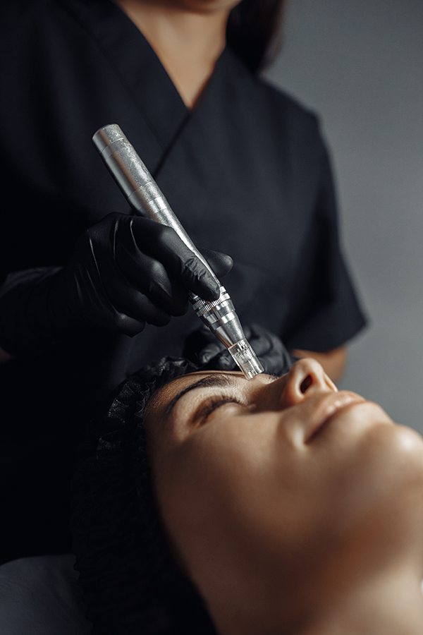 Cosmetologist make procedure for cleaning skin with steel tool from blackheads and acne in cosmetology center